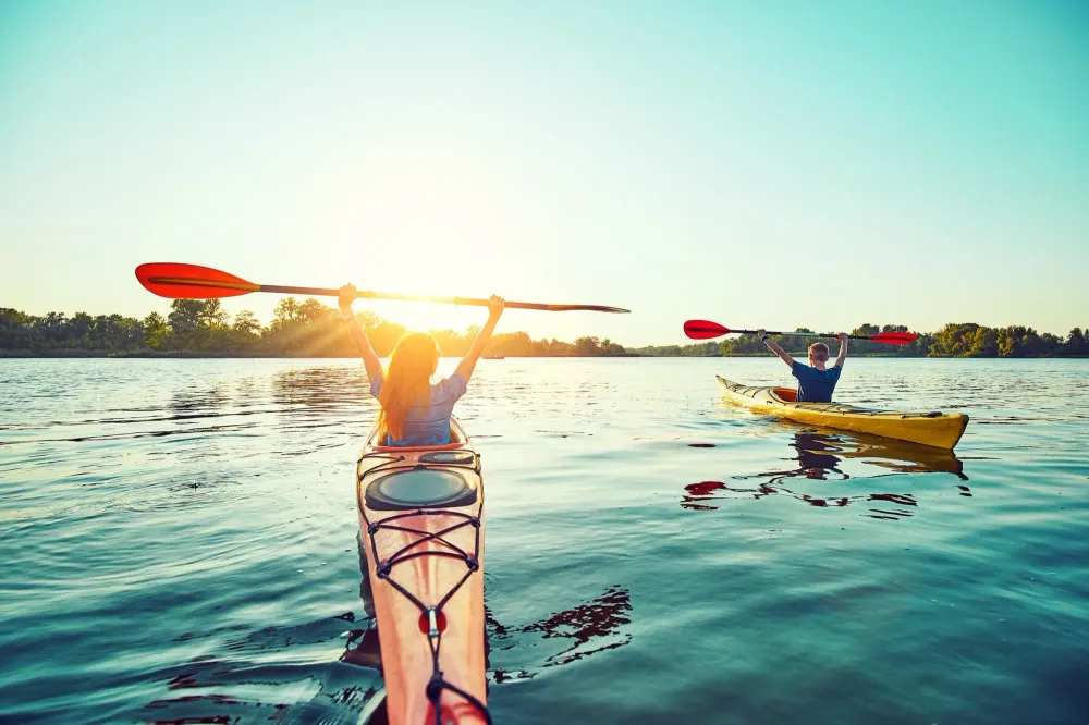 Two people kayaking at sunset